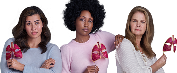 Three women with pink masks looking boldly ahead